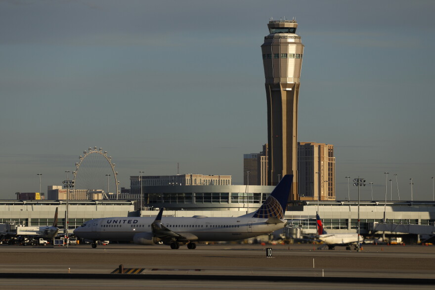 A plane takes off at McCarran International airport, Thursday, March 19, 2020, in Las Vegas. Officials at the airport said in a tweet that it will remain open with reduced operations after an air traffic controller tested positive late Wednesday, temporarily closing the control tower. (AP Photo/John Locher)