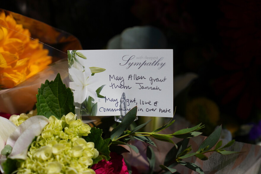 FILE - A note attached to flowers is placed outside of the Islamic Center of San Diego, the day after a shooting, May 19, 2026, in San Diego.