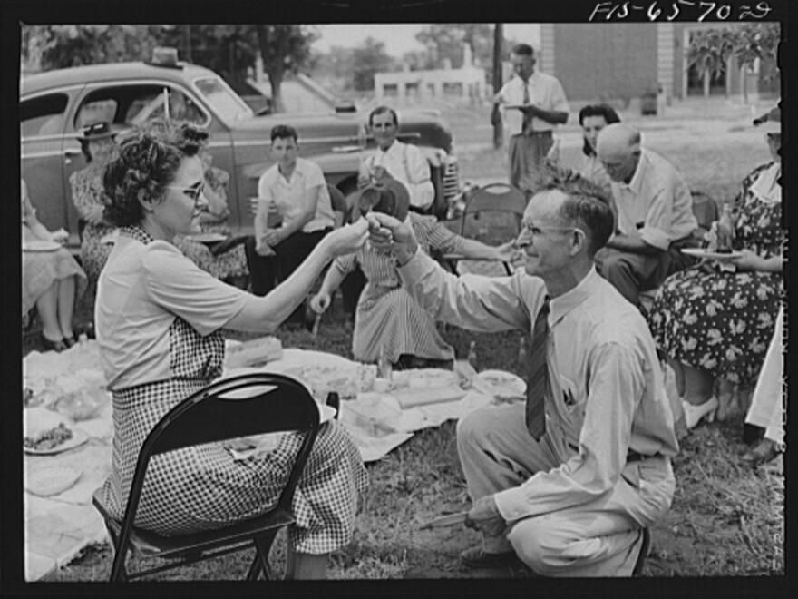 In this undated photo, a couple breaks a wishbone at a picnic during the Cotton Festival in Hayti, Mo.