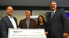 Gov. Eric Holcomb presented a check to the 933 Corridor Improvement Association as part of the Next Level Trails initiative.