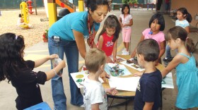 Kids playing with a teacher