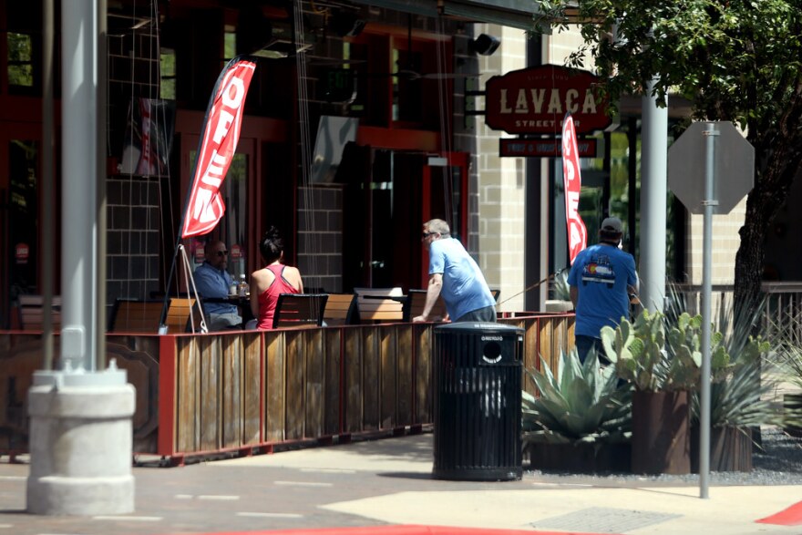 Patrons sit outside the Lavaca Street Bar in the Domain on May 1, as the Texas economy is slowly opens.