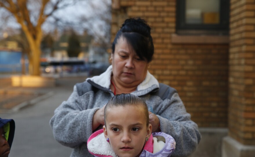 Cyndy Bulson fixes her granddaughter's hair before school starts at Stocking Elementary School.