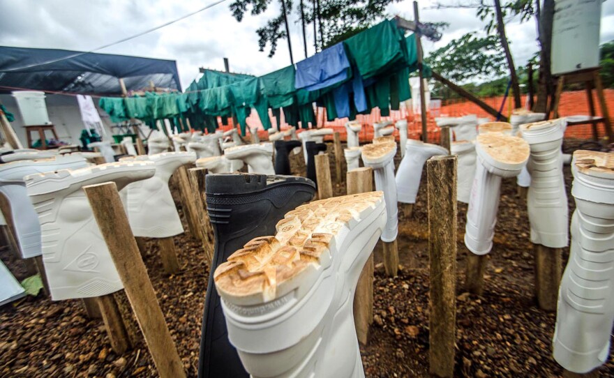 Wellington boots, part of health workers' protective gear, hang out to dry at the Doctors Without Borders' treatment center in Kailahun, Sierra Leone. Dr. Khan is now an Ebola patient in the center's isolation ward.