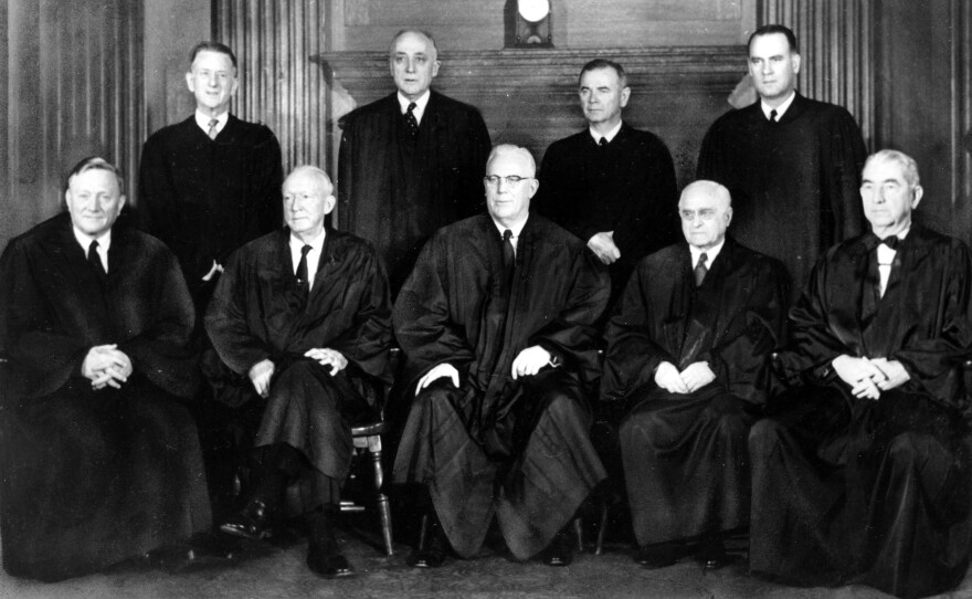 Justices of the U.S. Supreme Court pose for a portrait in their robes in Washington in 1958. Standing at left is Justice Charles Whittaker, who resigned from the court after having a nervous breakdown.
