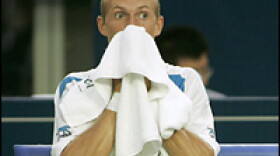 Nikolay Davydenko wipes his face during a match in the China Open Tennis Tournament, Sept. 13, 2007.
