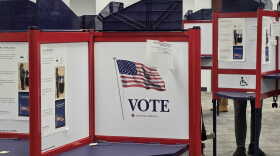 Polling booths with "vote" signs 