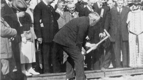 President Warren G. Harding pounds the golden spike in a July 15, 1923 ceremony marking completion of the railroad line from Seward to Fairbanks