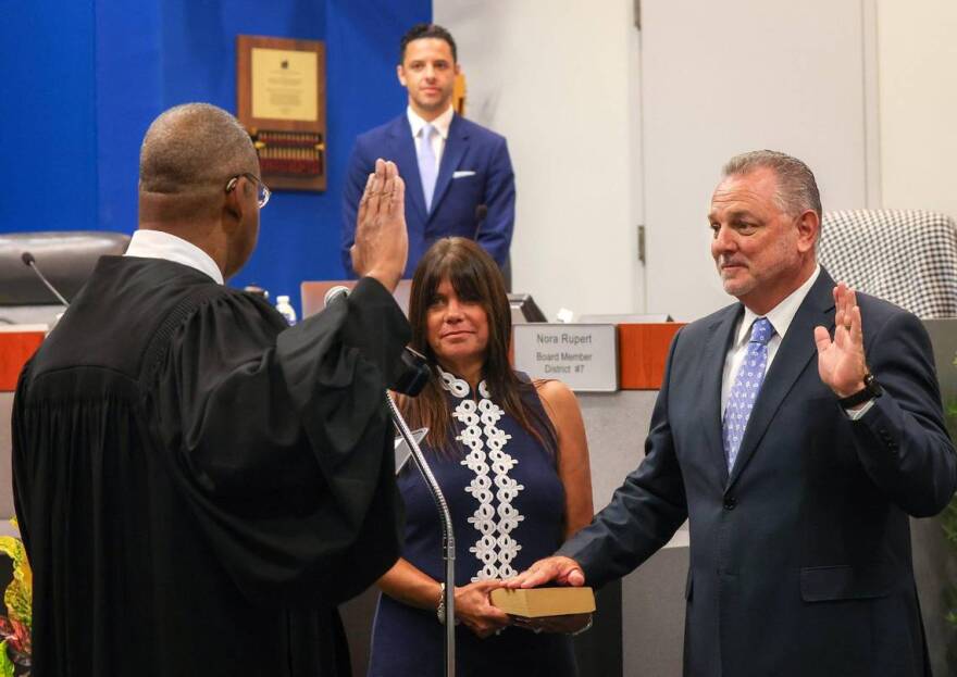 Broward Circuit Judge Elijah H. Williams, left, swears in Peter B. Licata, right, with his wife Judy holding the Bible, as the superintendent of Broward County Public Schools at the district's headquarters in Fort Lauderdale, FL on Tuesday, July 18, 2023.