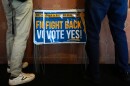 Signs in support of the Virginia redistricting referendum are seen as Jen Strozier and Doug Mock, members of the Goochland Democratic Committee, order lunch at GG's Pizza, Thursday, April 2, 2026, in Maiden, Va.