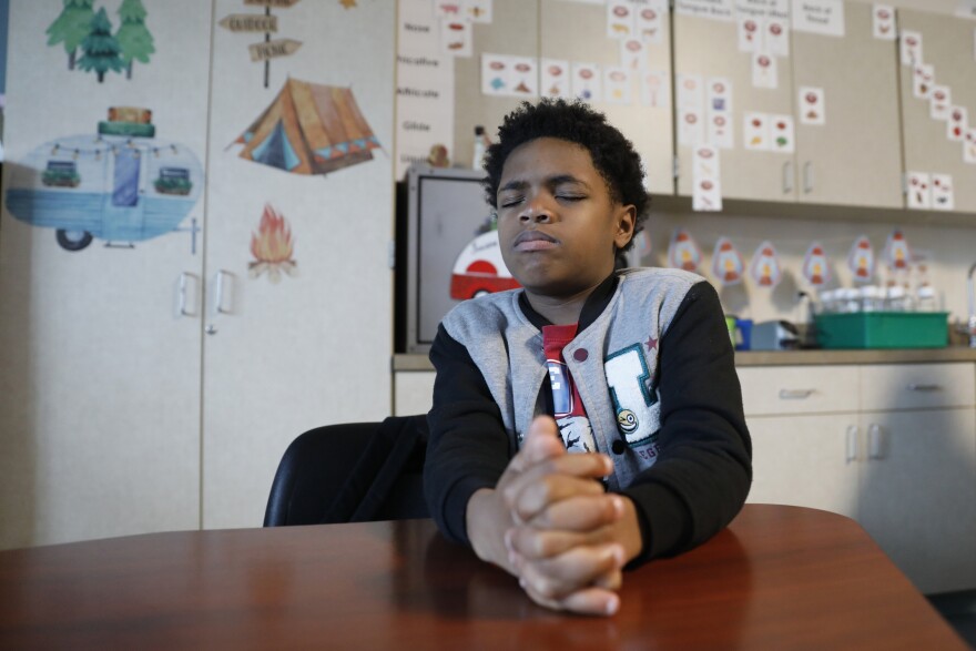 A student named RaMeir focuses during the morning mindfulness lesson. Teachers say the morning sessions help the kids practice mindfulness throughout the day.