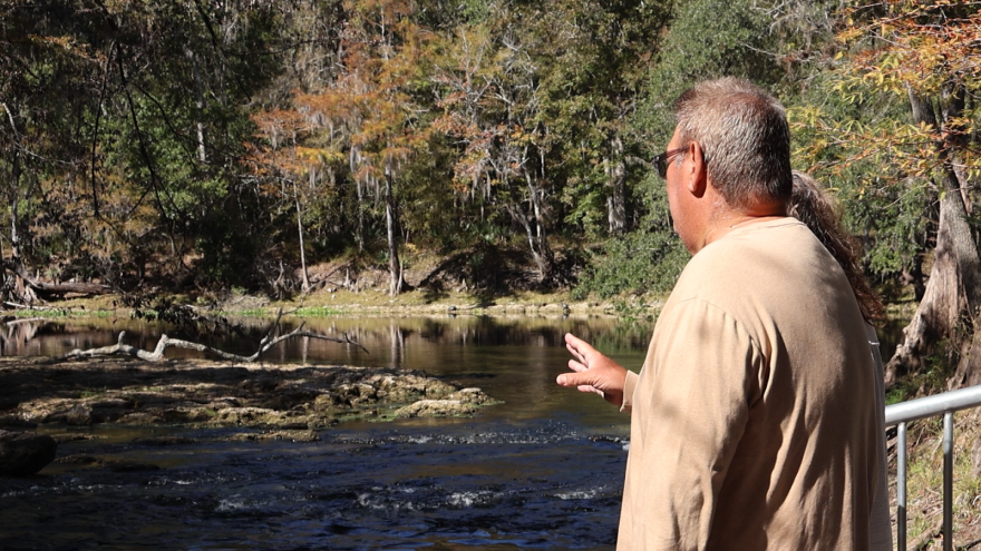 Thomas Stiers señala el lugar donde la piedra caliza está expuesta, un indicio de la sobreexplotación del agua del manantial. Foto por: Marina Meretz.
