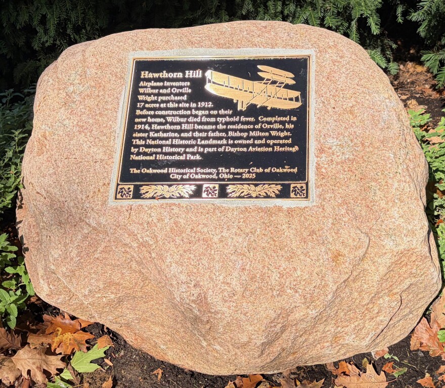 A granite stone with a bronze plaque marks Hawthorn Hill as a historic landmark in Dayton