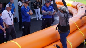 Members of Naples Airports’ operations team learn how Tiger Dam flood barriers protect against storm surge. Naples Airport purchased 3,000 feet of durable tubes to protect buildings and equipment during future hurricanes.