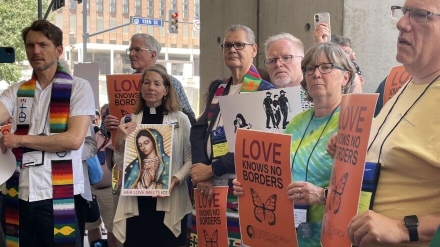 Clergy attending the United Church of Christ General Synod gathered outside of the Kansas City Convention Center in early July 2025 The group passed a resolution against the Trump administration’s tactics on immigration.
