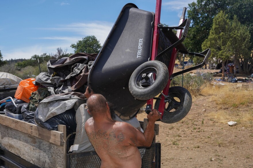 A man loads a truck with possessions from a homeless encampment on July 30, 2025.