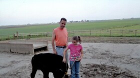 Emma Yerkey and her dad, Tim Yerkey, with the ribbon-winning calf they raised together.