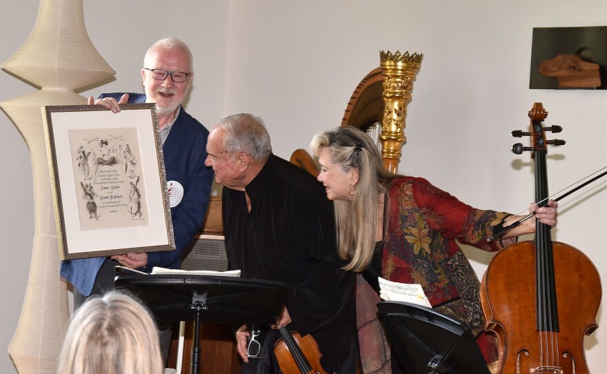 Christopher Scholz, President, presenting HVCMC Artistic Directors Jaime Laredo and Sharon Robinson with a lithograph in recognition of their 25 years of creative leadership. Hudson Valley Chamber Music Circle's 2025 Spring Gala (Photograph courtesy of Patrick McMullan/PMC.)