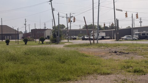 Along 3rd Avenue North, west of downtown Birmingham, sits a vacant lot with tall grass and signs of a burned-down structure.