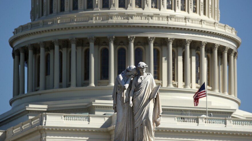 The Peace Monument stands in front of the U.S. Capitol where an American flag flies at half-staff following a mass shooting in Las Vegas late Sunday that killed over 50 people.