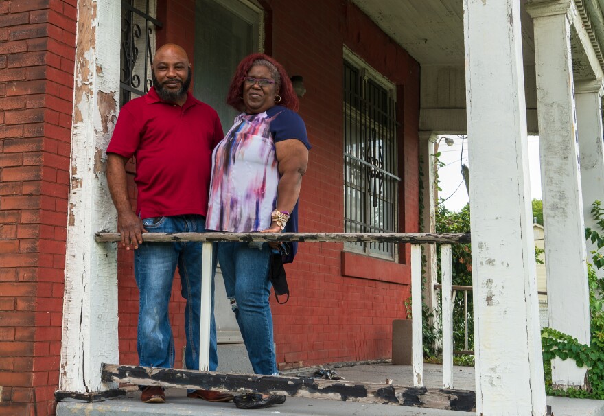 Damon Giboney and Patricia Dees stand on the porch of their home in St. Louis on July 29, 2020.