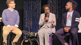 Sycamore Creek Church pastor Tom Arthur sits with Willye Bryan and Prince Solace on stools. Bryan is speaking into the mic. 