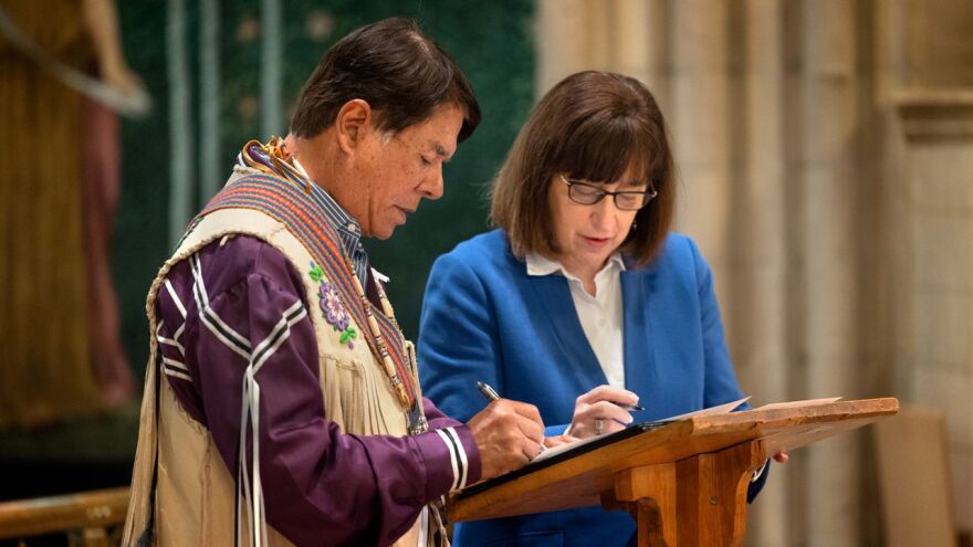 Ray Halbritter representing the Oneida Indian Nation, and President Martha E. Pollack, sign documents that repatriate ancestral remains from the university to the Oneida Indian Nation.
	