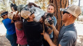 Jesus GuzmÃ¡n (right) and fellow Higher Ground veterans participate in a team-building exercise during a hike in Big Bear, Cal.