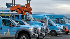 In this Jan. 14, 2019, file photo, Pacific Gas & Electric vehicles are parked at the PG&E Oakland Service Center in Oakland, Calif.