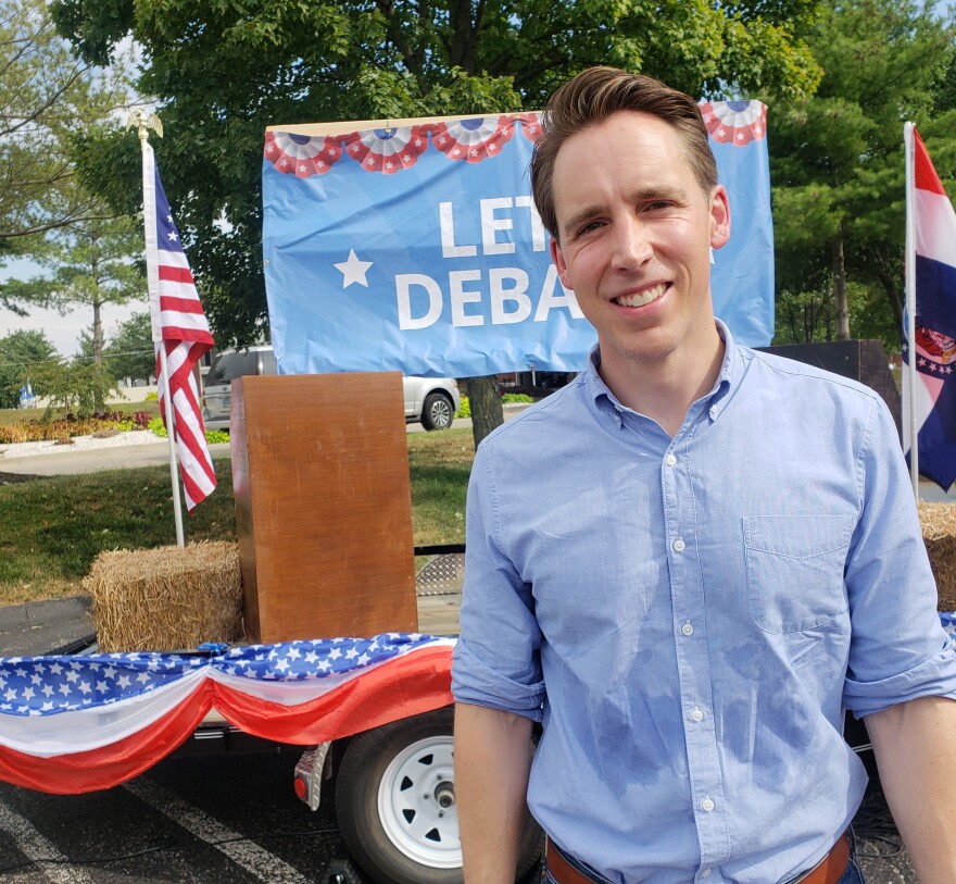 Hawley stands in front of his traveling debate trailer, parked Wednesday in St. Charles.
