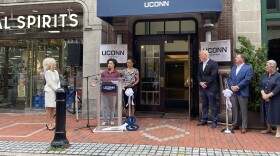UConn students Kai Blatchford and Arielle Crichlow speak outside the entrance to UConn's Pratt Street residence hall before a ribbon cutting ceremony to mark its opening.