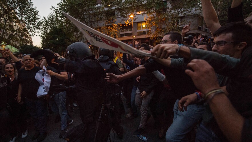 Demonstrators clash with Spanish National Police officers outside the headquarters of a pro-independence political party in Barcelona, Spain, on Wednesday.