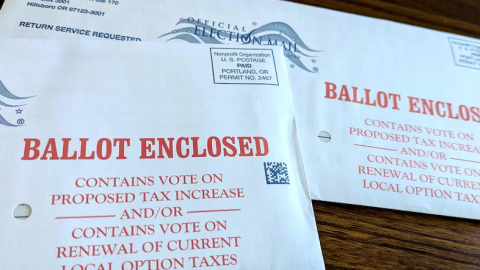 Two unopened Washington County ballots for Oregon's 2026 primary election sit on a table.
