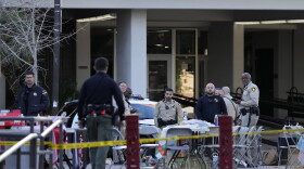 Las Vegas police stand near the scene of a shooting at the University of Nevada, Las Vegas, Thursday, Dec. 7, 2023, in Las Vegas.