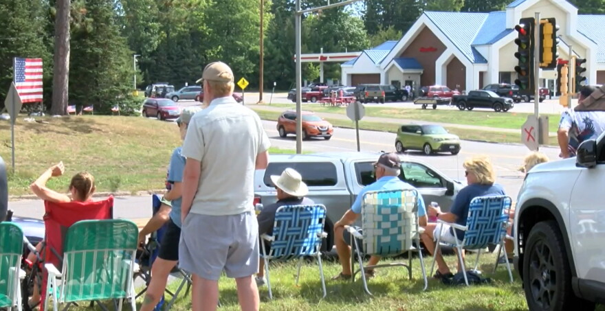 Northwood residents wave to departing tourists at the end of the Labor Day weekend