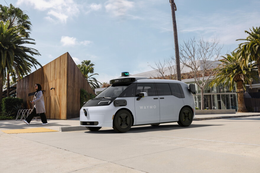 A white van-type  with Waymo written on it