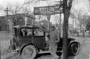John "Bennie" Taylor was a mechanic at Robert L. Simons' Body Works at 928 Washington Street. Numerous other businesses are visible in the background. Image digitized from glass plate negative.