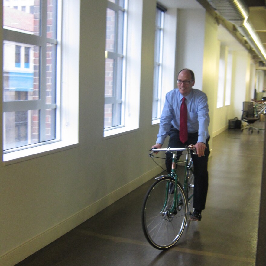 Perez bikes in the offices of Shinola, a company that manufactures high-end watches and bicycles.