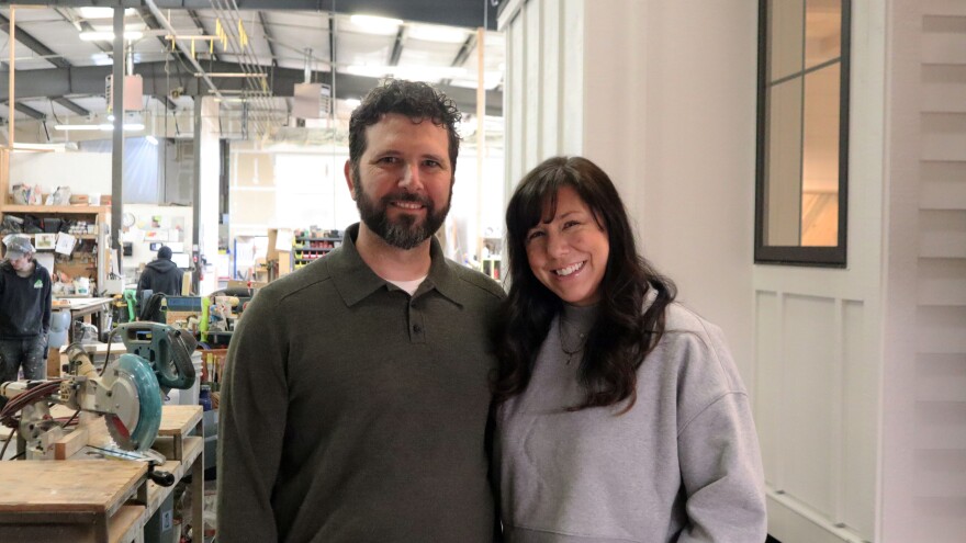 Tru Form Tiny co-founder Jen Carroll (left) and Malia Schultheis (right) stand in front of a nearly completed home.