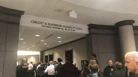 A line of people gathers outside the Hamilton County courtroom for the hearing of the suspect accused of shooting his teacher and classmate at Noblesville West Middle School.