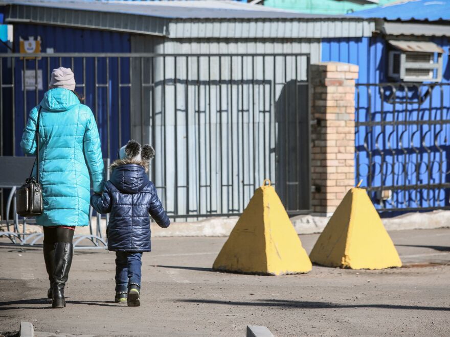 Russia has created a list of Ukrainian civilians who would be detained or killed in case of an invasion, the U.S. says. Here, people walk past anti-tank barriers in the town of Avdiivka, on the eastern Ukraine front-line with Russia-backed separatists.