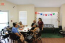 Residents of the Olivares Senior Community talk with the building's assistant manager Joann Olveda after electricity was restored on Aug. 30, 2026.