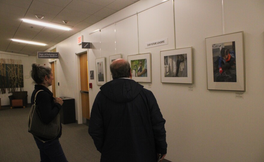 Becky Field speaks on Wednesday, Jan. 14, 2026, at a reception for her latest exhibit of "Different Roots, Common Dreams: New Hampshire's Cultural Diversity," a photo project on view at the Dartmouth-Hitchcock Medical center through March.