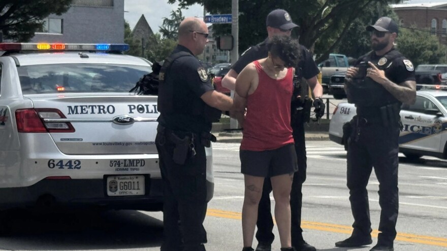In this photo provided by WHAS-11 News, a protestor is seen detained by police outside the federal courthouse where ex-Kentucky police officer Brett Hankison, convicted of using excessive force during the deadly Breonna Taylor raid, is taking place, Monday, July 21, 2025, in Louisville, Ky. (Alyssa Newton/WHAS-11 News via AP)