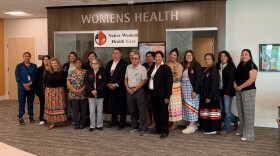 Oglala Sioux Tribal President Frank Star Comes Out stands with staff of Native Womens Health Clinic during its reopening ceremony. Due to staffing shortages, the clinic hadn't seen patients since April 2023. The clinic is reopening with a midwife and registered nurse on staff.