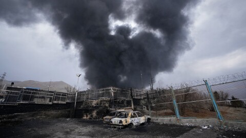 FILE - A thick plume of smoke rises from an oil storage facility hit by a U.S.-Israeli strike in Tehran, Iran, March 8, 2026. 