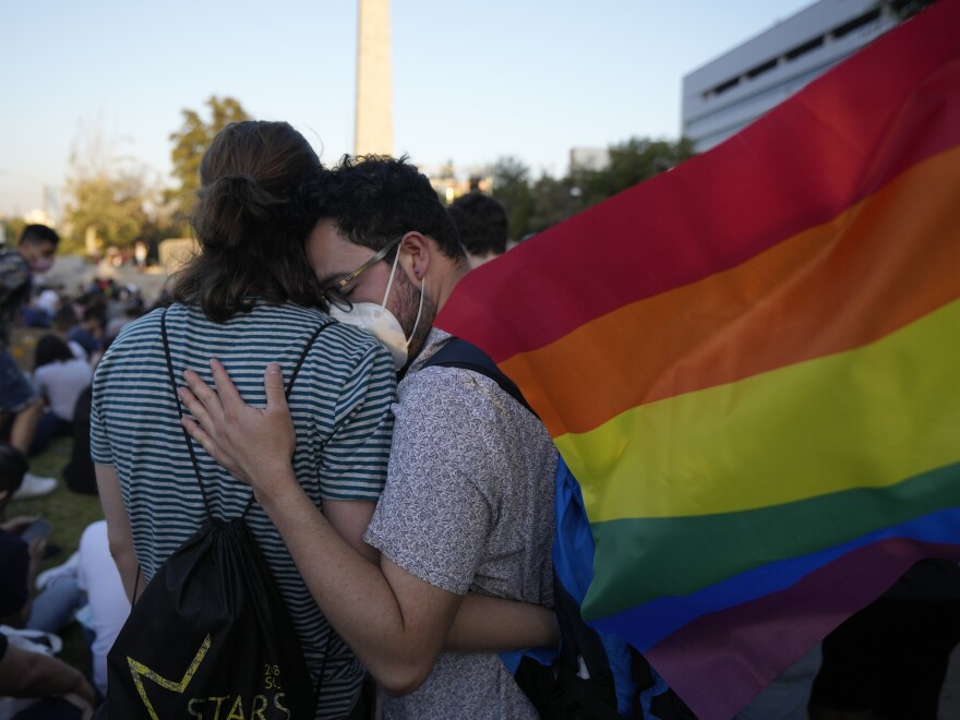 Members of the Movilh — Movement for Homosexual Integration and Liberation — celebrate after lawmakers approved legislation legalizing marriage and adoption by same-sex couples, in Santiago, Chile, on Tuesday.