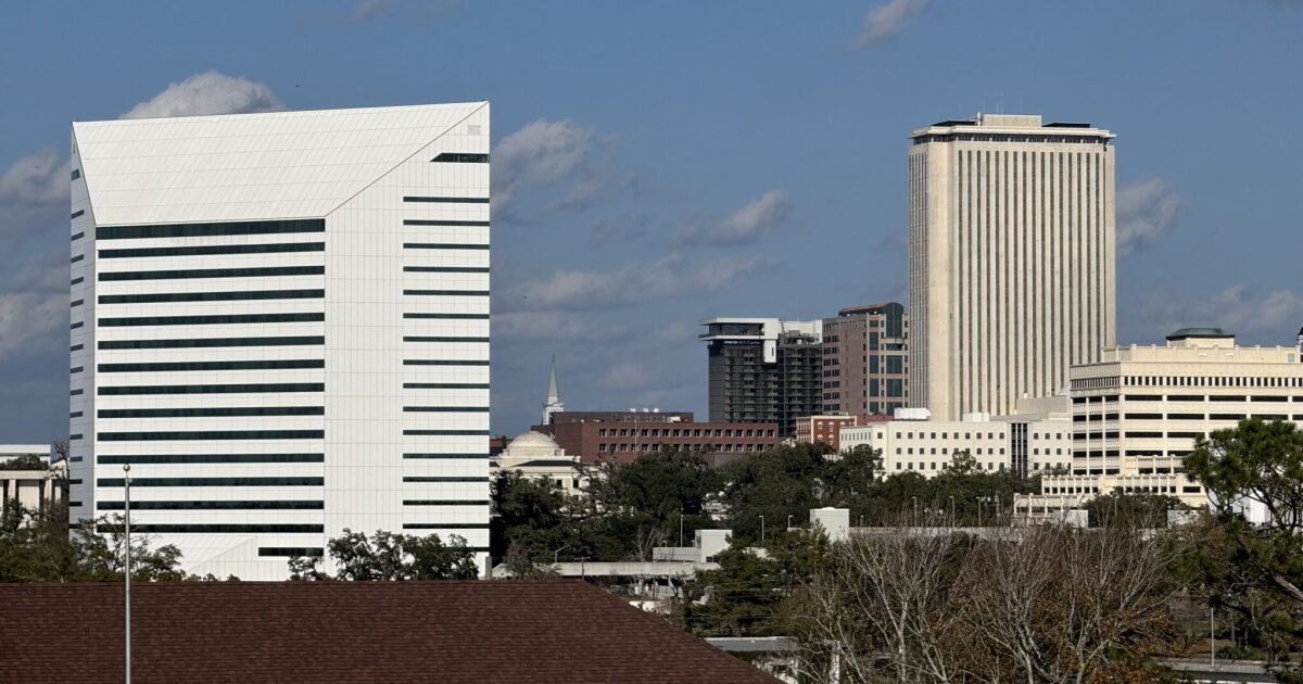 The Turlington Building, which houses the Florida Department of Education, stands in the foreground, with the Tallahassee skyline, including the Capitol building, beyond. Photo taken from the FAMU campus on Dec. 31, 2024.