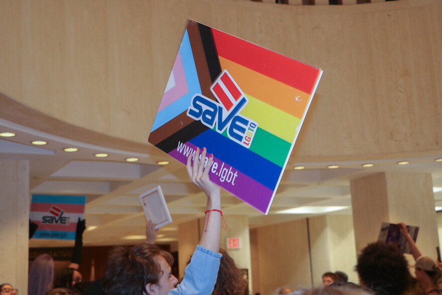  A protestor holding a LGBTQ+ sign at the student-led protest at the Florida Capital.