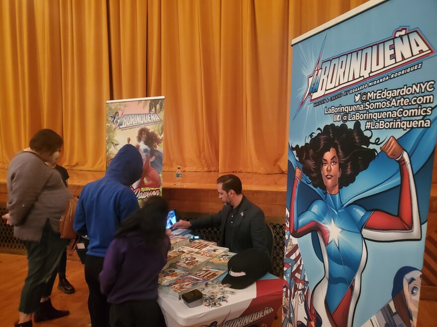 "La Borinqueña" author Edgardo Miranda-Rodriguez signs autographs of his comic book in Holyoke, Massachusetts. 